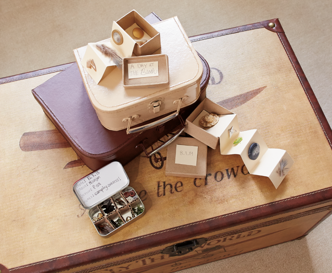 A treasure box sits on the floor, suitcases and jewelry boxes strewn atop it.
