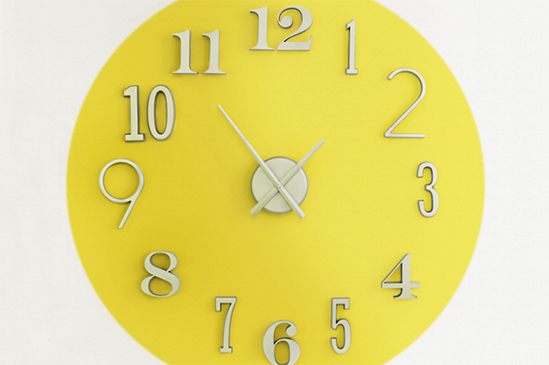 A giant wall clock with the color sunlit gold as the background color.