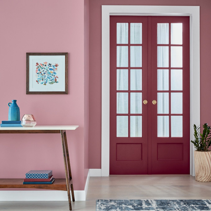 Closed French doors in an entryway. Walls are painted the color jasmine flower.