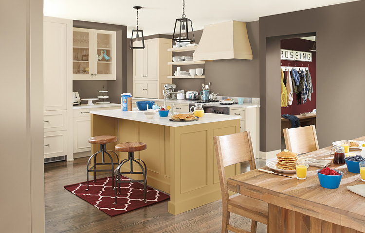 A family enjoying breakfast in a large kitchen with a dining table and island.