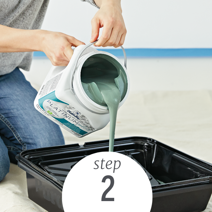 person pouring Dutch Boy paint into a roller tray