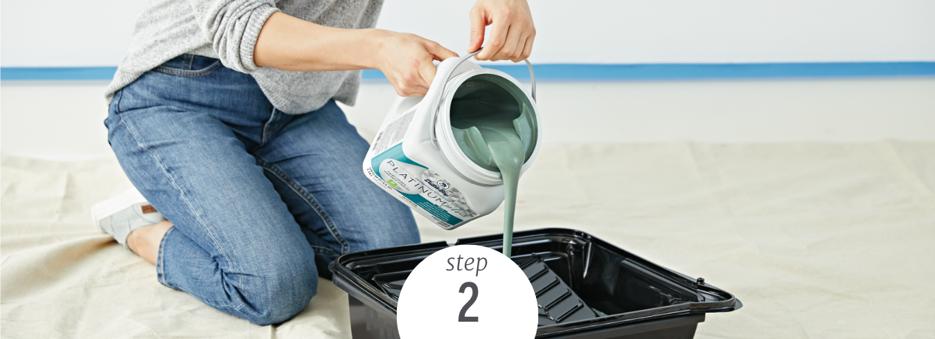 person pouring Dutch Boy paint into a paint tray