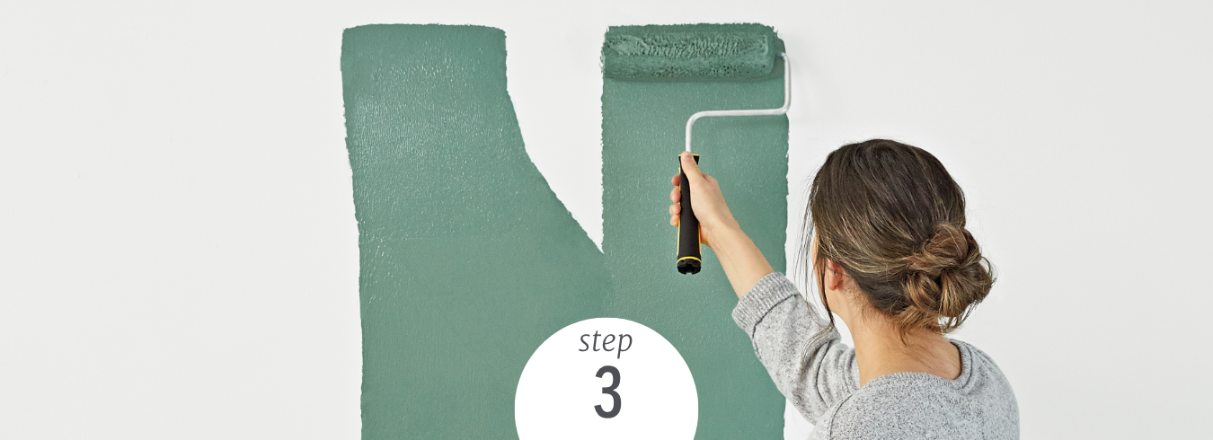 person pouring Dutch Boy paint into a paint tray