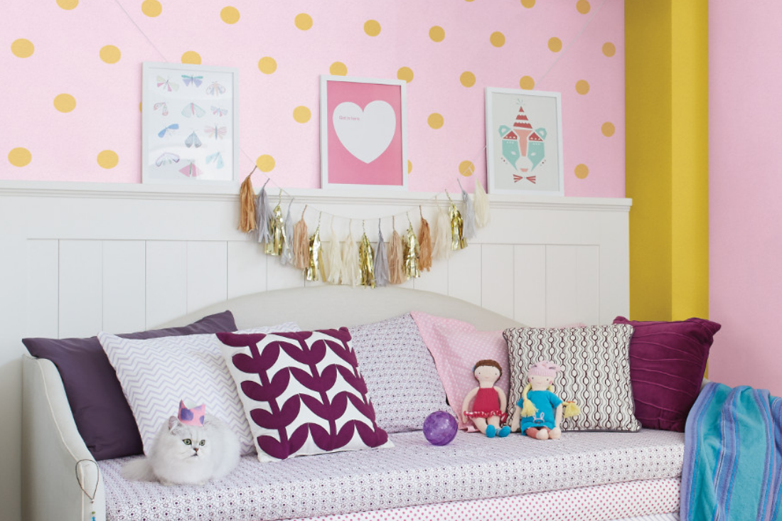 bedroom with bed, headboard and brightly colored pillows
