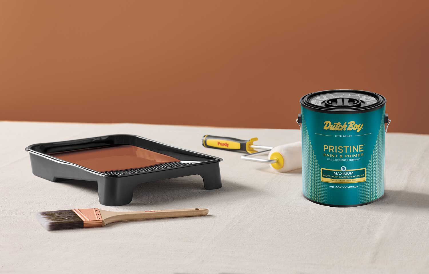 Gallon can of Dutch Boy Pristine paint alongside a roller tray, Purdy roller and Prudy brush.