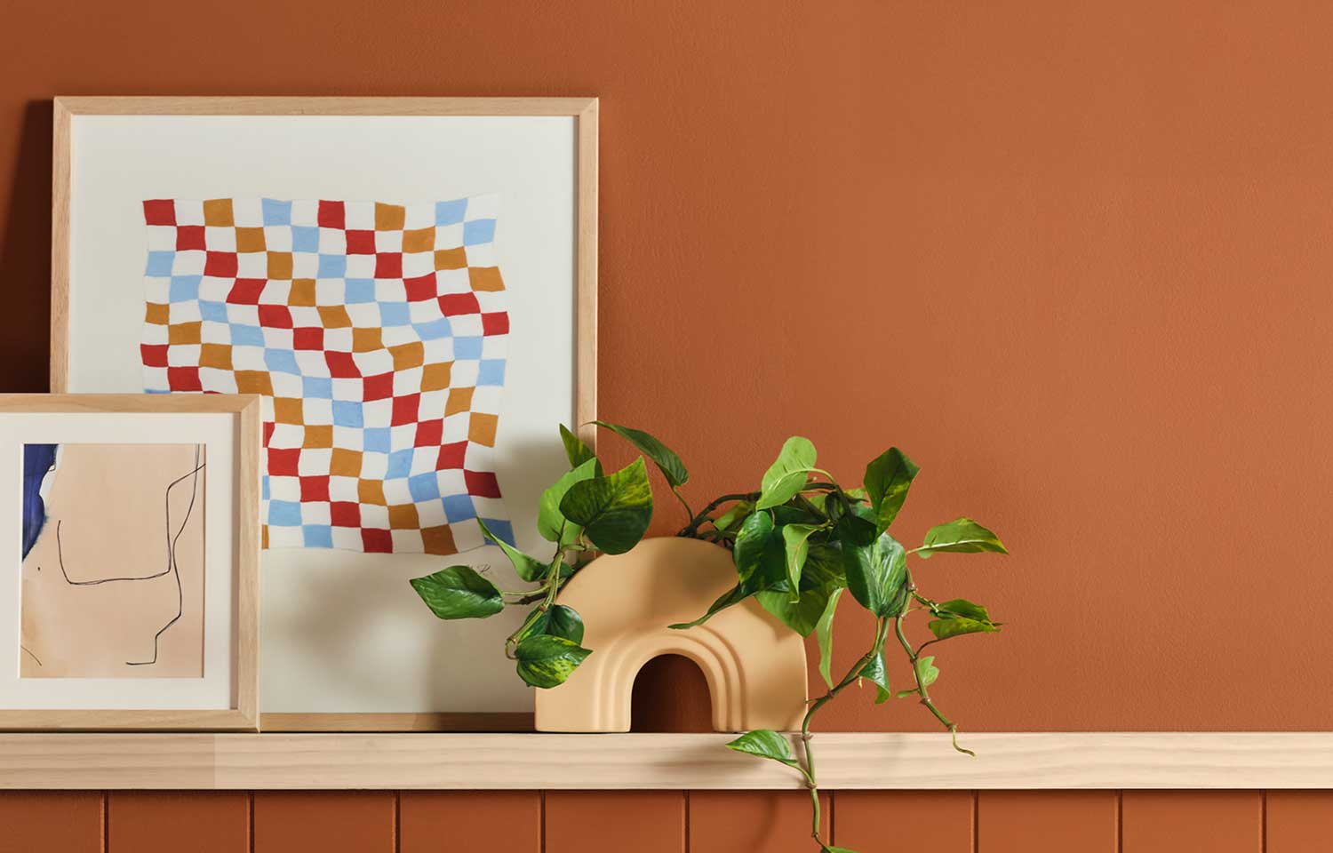 Deep Rooted Dutch Boy Color of the Year on a wall with a shelf and picture frame