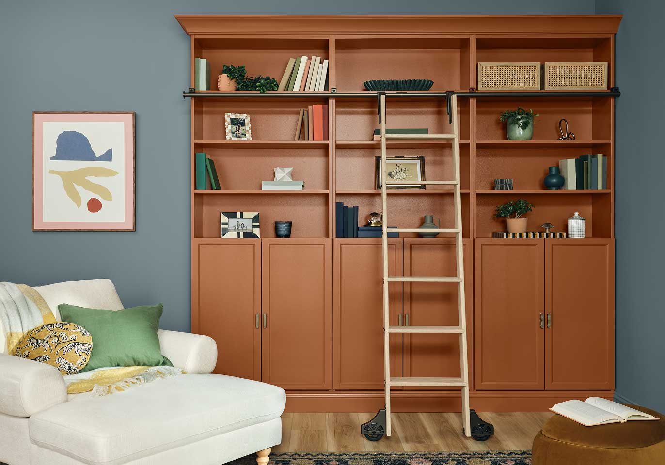 A reading nook painted in Felted Blue along with shelves painted in Deep Rooted.