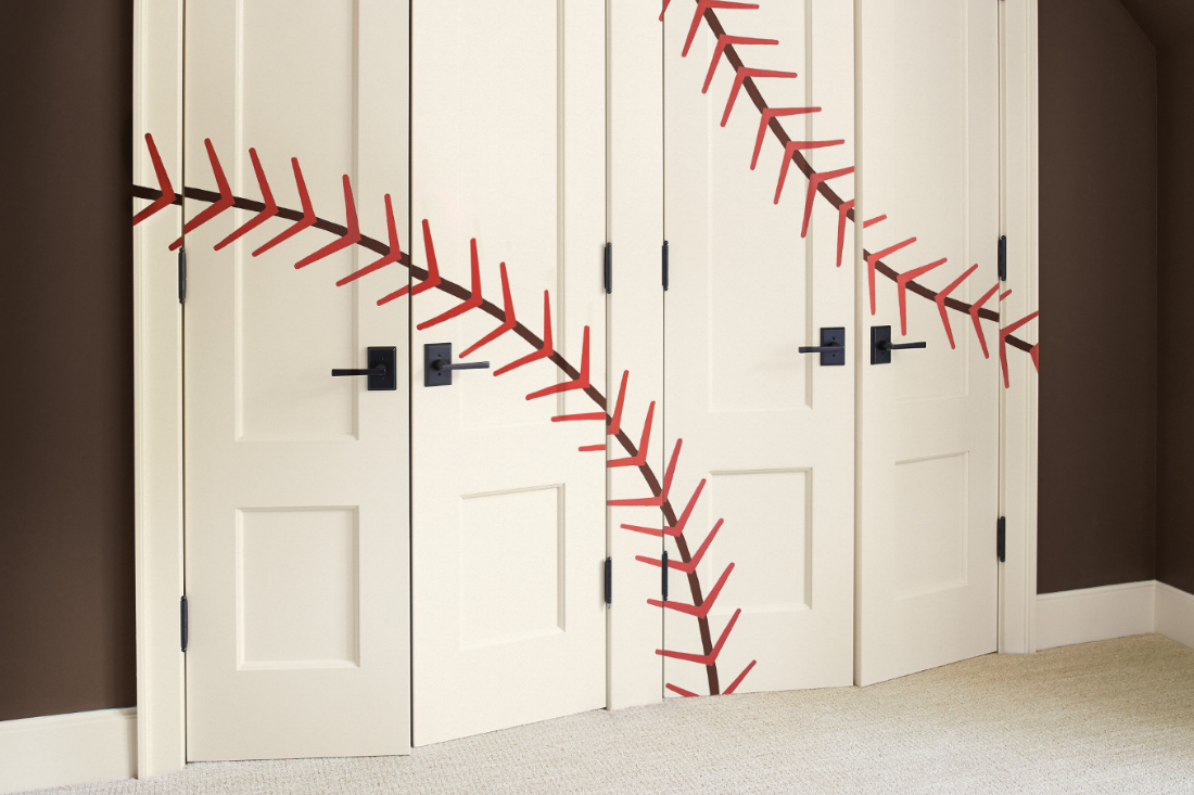 Bedroom closet French doors with baseball stitching painted onto them. Wall is painted charred.