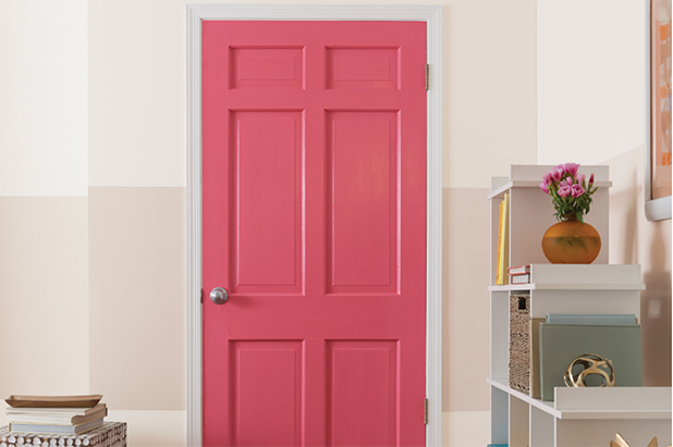 Modern-styled living room with a red door and a pale colored wall with a beige stripe across it.