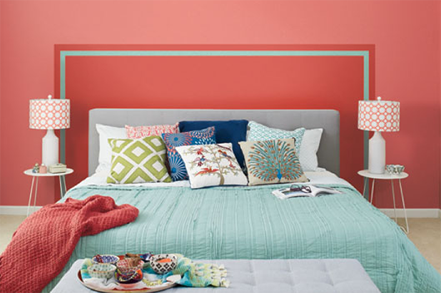 Bedroom, king bed with a paint-on headboard in the color luscious scarlet, trimmed in the color teal seagrass. Rest of wall painted carmela coral.