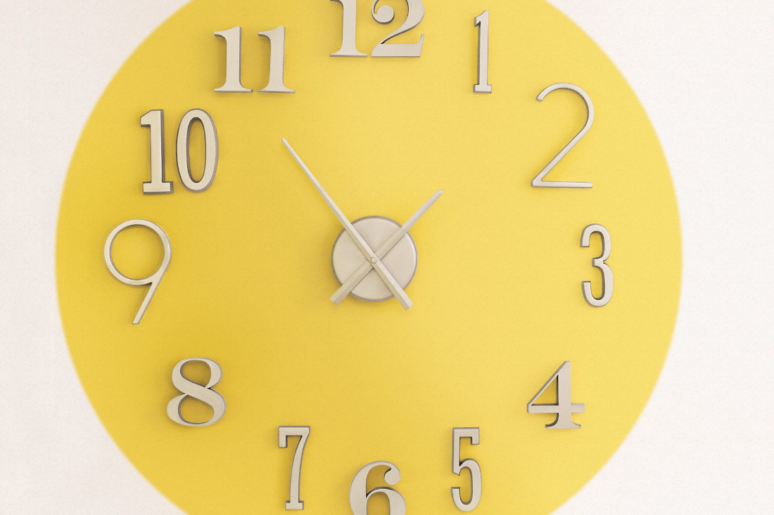 A giant wall clock with the color sunlit gold as the background color.