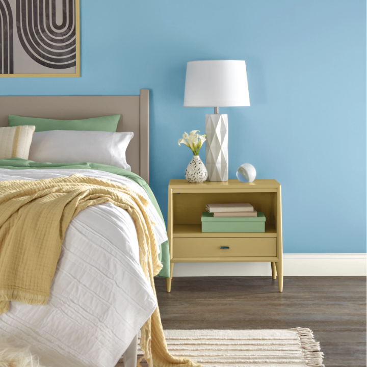 blue bedroom walls with bed and nightstand