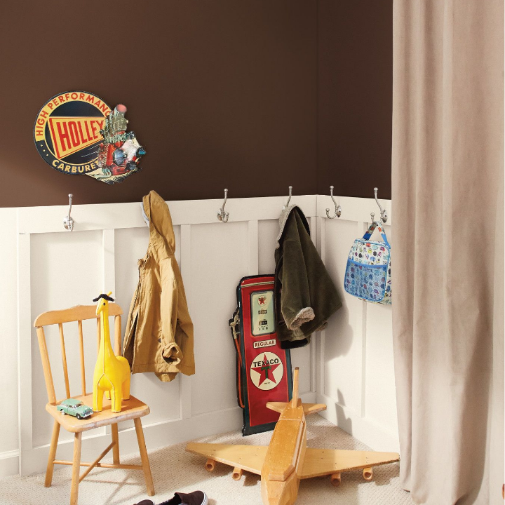 brown walls with hooks for hanging clothes and jackets