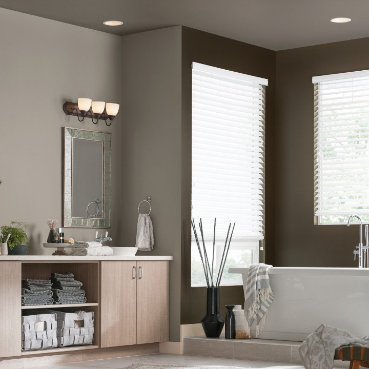 grey walls in a bathroom with vanity and towels