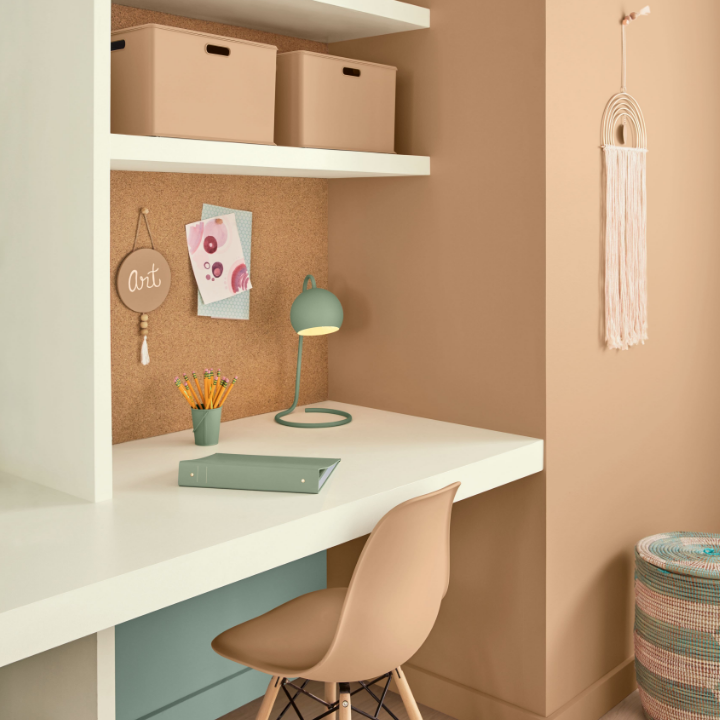 orange walls in an office with chair and desk