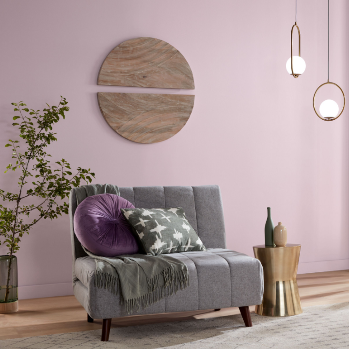 purple walls with a small couch and lights
