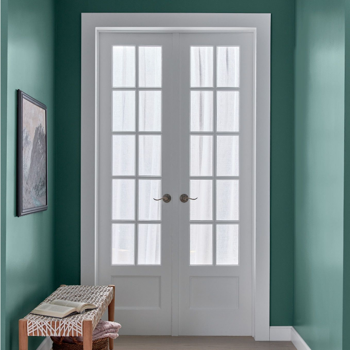 entryway with white doors, bench