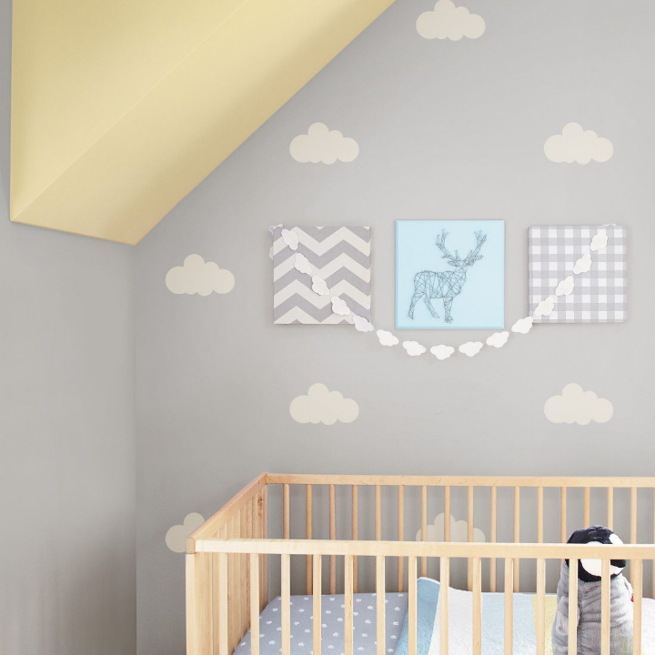 Nursery with crib and stenciled wall