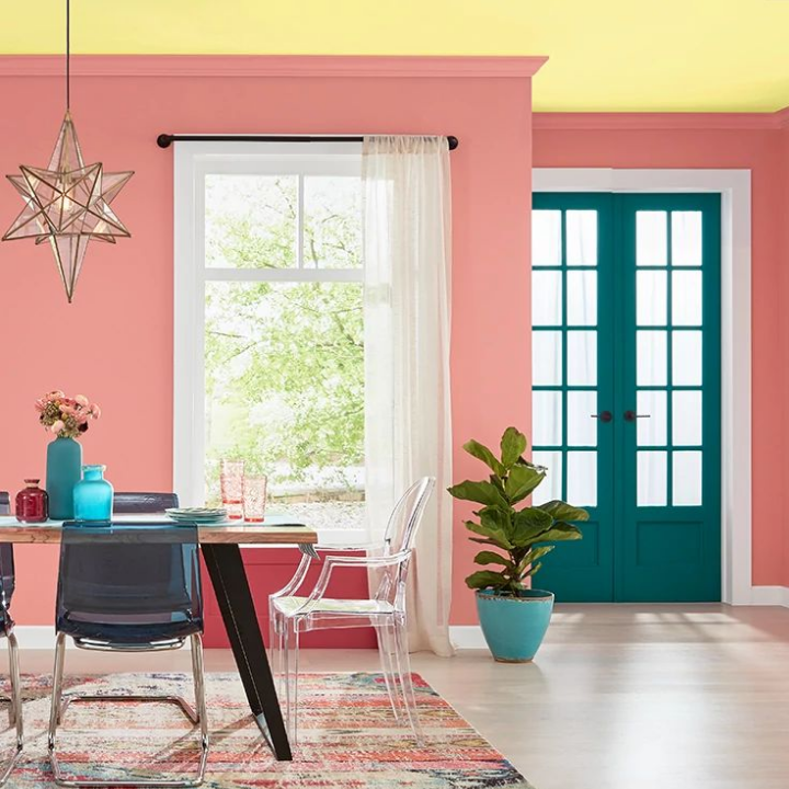 dining room with modern chairs, a doorway in bright colors