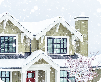 Exterior of a home in the winter with falling snow.
