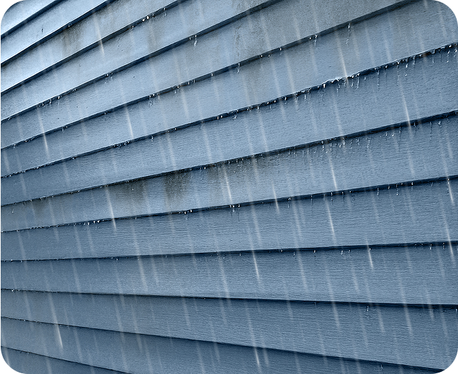 Exterior home siding with dirt and stains being washed away by the rain.