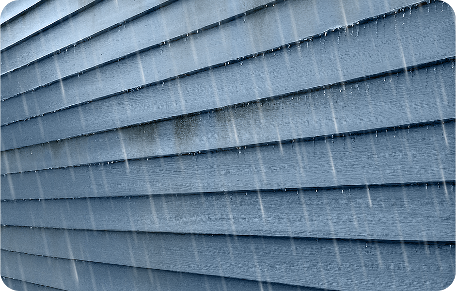 Exterior home siding with dirt and stains being washed away by the rain.