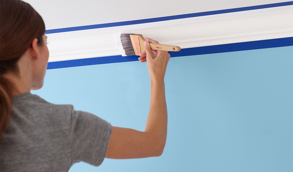 person painting crown molding