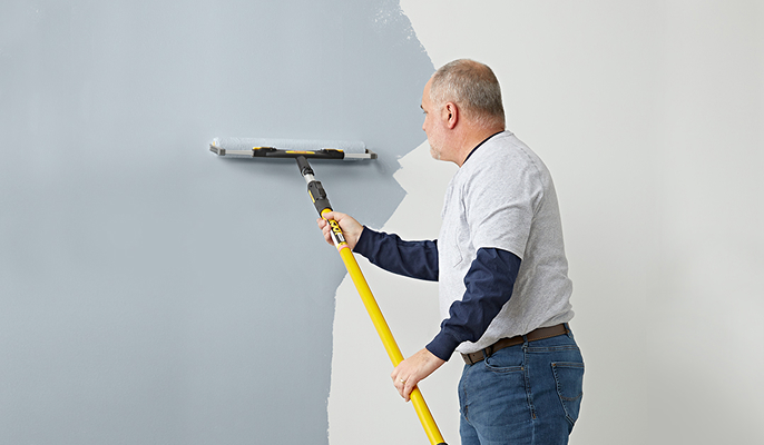 person using a Purdy roller and extension