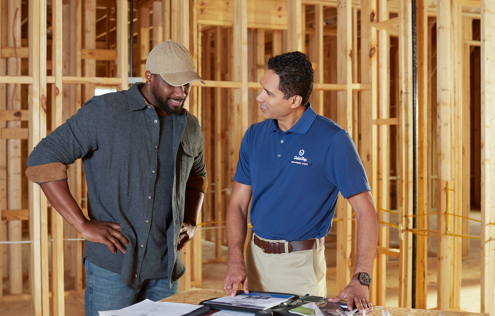  Professional Contractor and Dutch Boy Professional Series field rep smiling, next to a residential home.