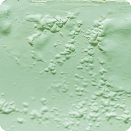 A wall painted green long ago is showing signs of major blistering and wrinkling.