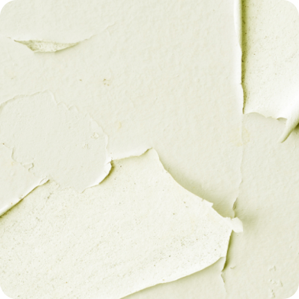 A light green wall painted long ago is showing signs of major peeling. 