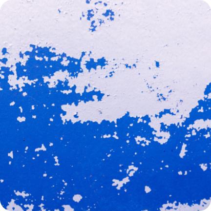 A wall painted blue long ago is showing signs of major surface color variation. 