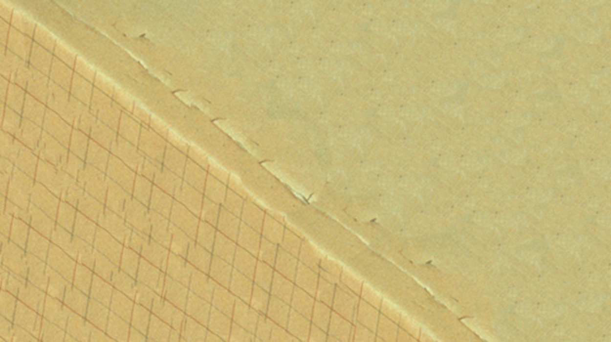 A wall painted yellow long ago is showing signs of flaking.