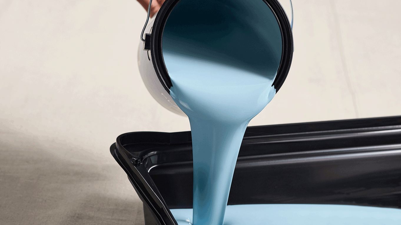 Pouring Dutch Boy paint into a paint tray
